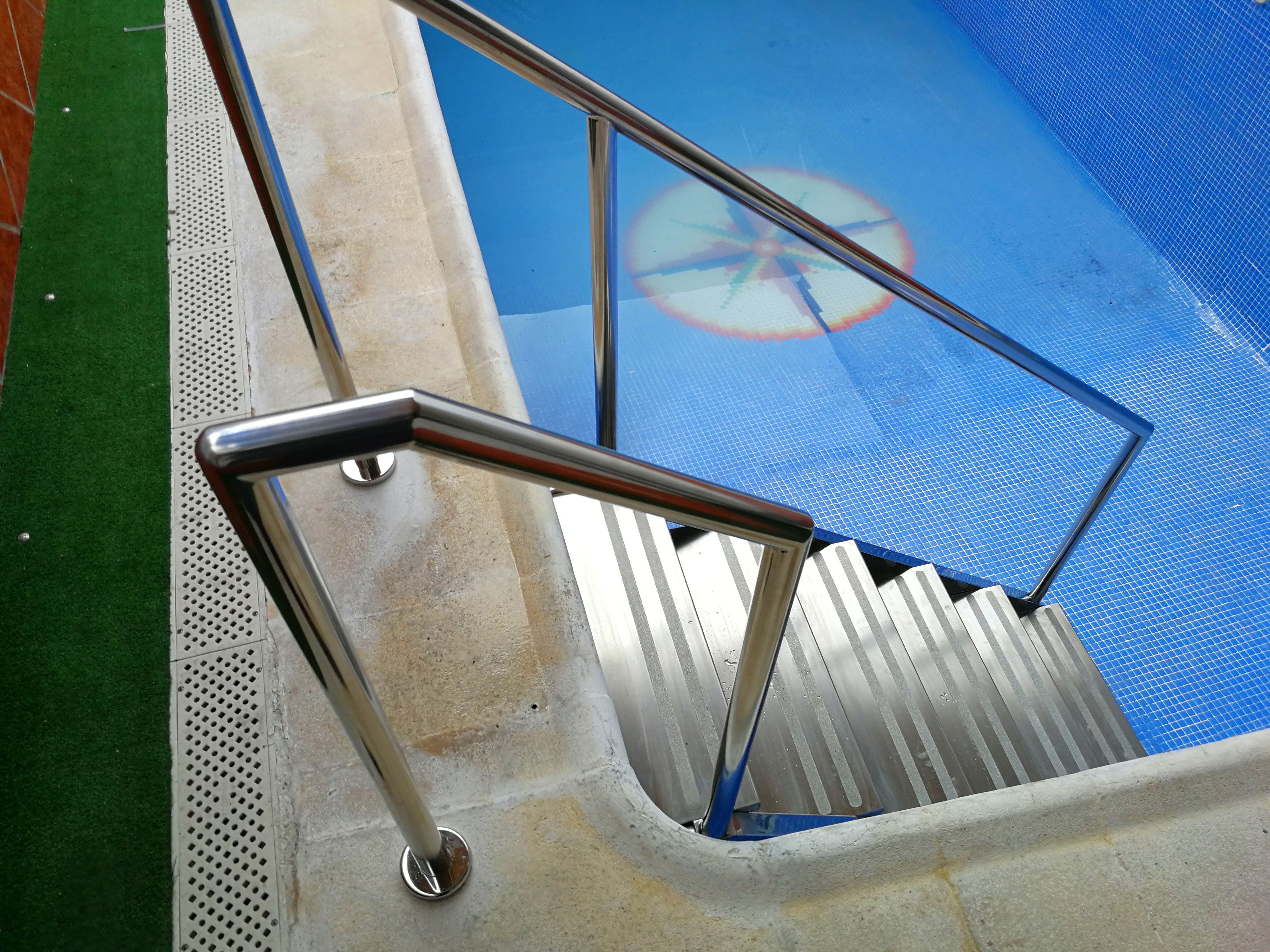 Escaleras con barandilla de acceso a piscina diseñada y fabricada a medida con acero inoxidable calidad AISI 316. }}