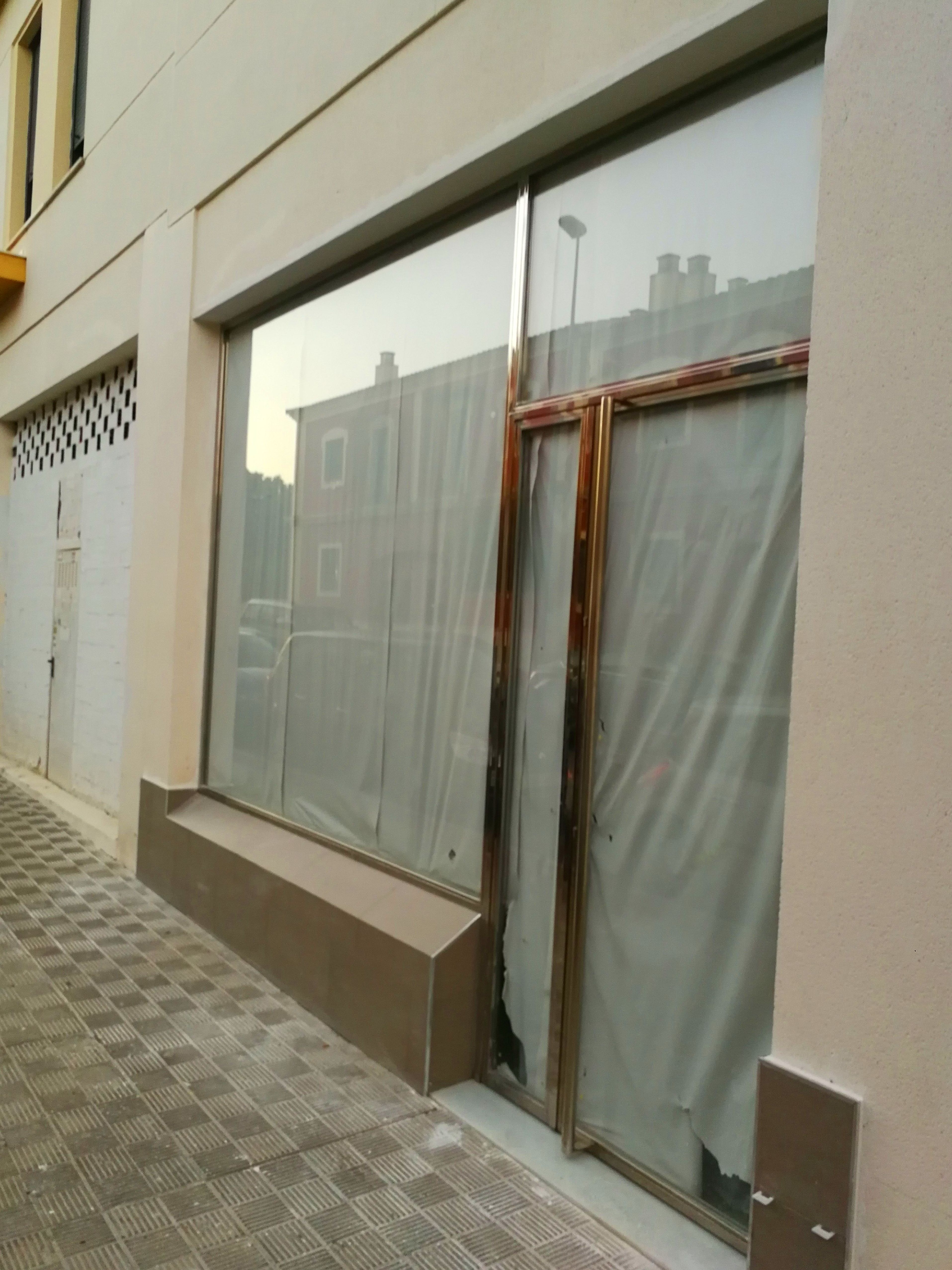 Puerta y escaparate de acero inoxidable y vidrio diseñada y fabricada a medida para local comercial Puerta y escaparate de acero inoxidable y vidrio diseñada y fabricada a medida para local comercial