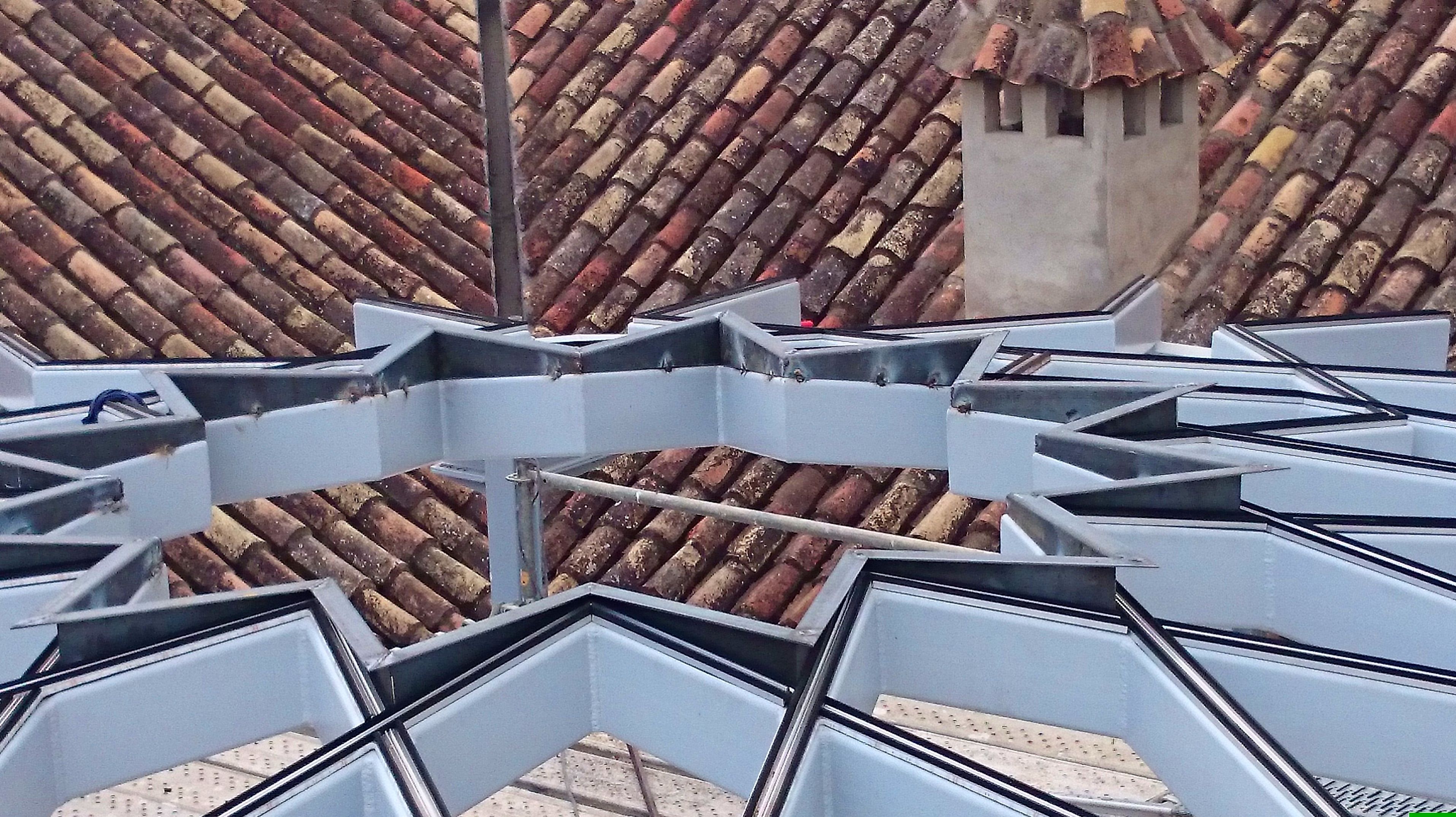 Estructura de techo de acero negro con forma de estrella formando una base totalmente plana para alojar vidrio de la misma forma adaptado a patio andaluz de palacete Estructura de techo de acero negro con forma de estrella formando una base totalmente plana para alojar vidrio de la misma forma adaptado a patio andaluz de palacete