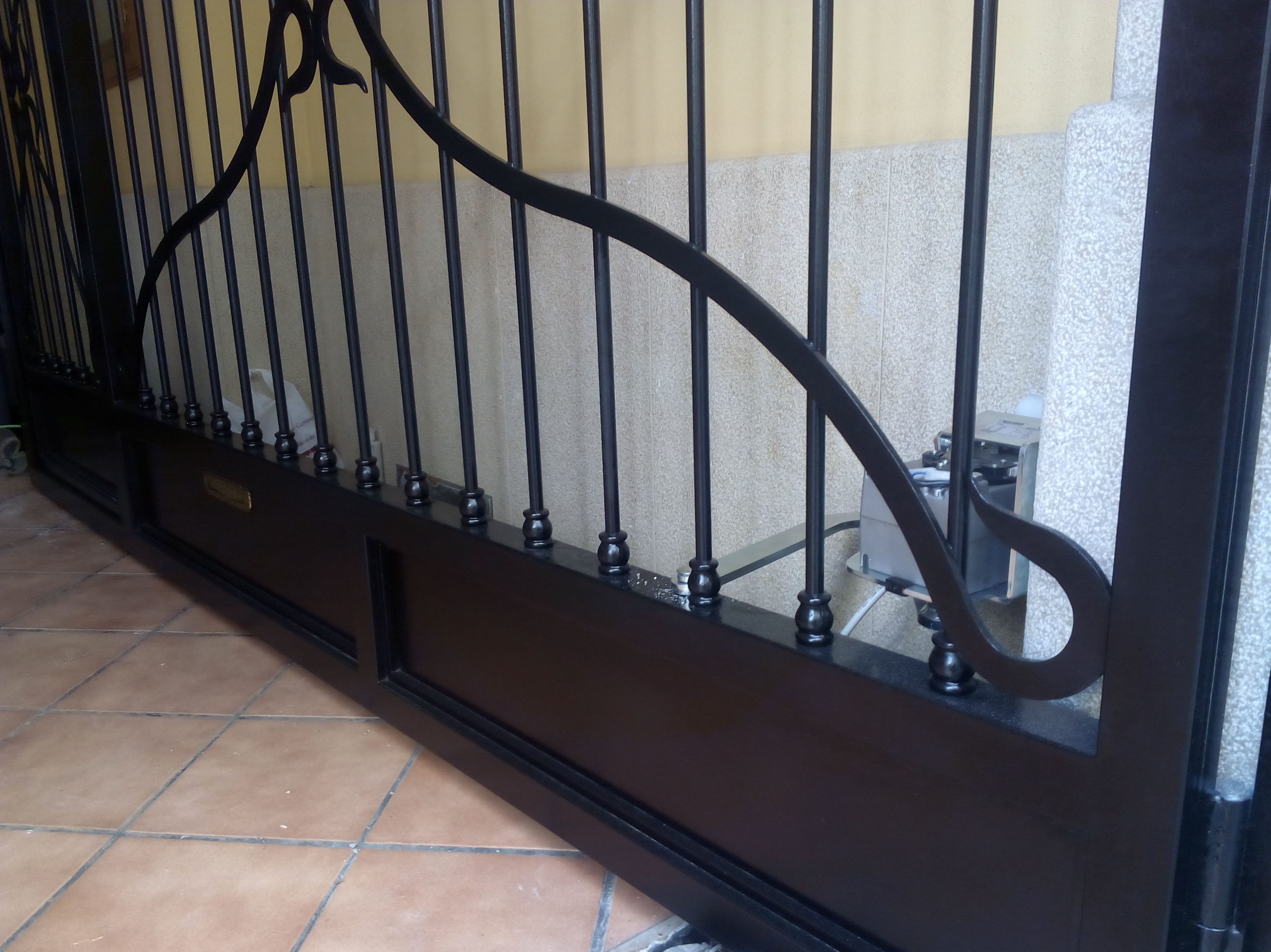 instalación de motor con brazo articulado de puerta batiente 